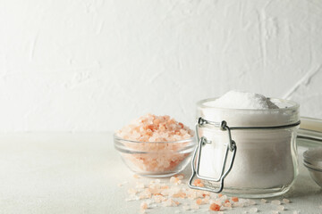 Bowls and jar with salt on white - gray table