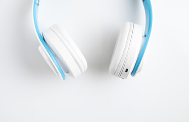 White wireless headphones on white background.