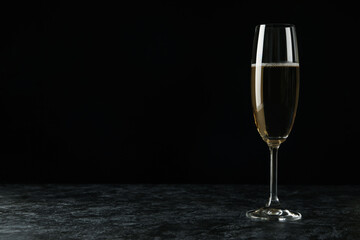 Glass of champagne drink against black background
