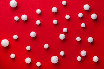 Christmas red background with white snow ornament decoration. Flat lay New year minimal composition.