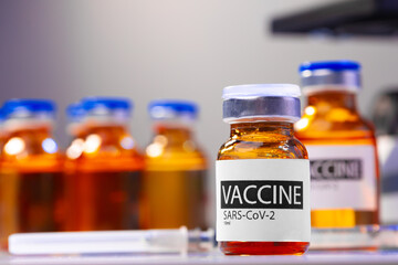 Vaccine vial of Sars-cov-2 on table in laboratory