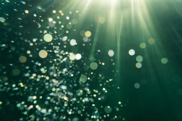 Underwater picture in the baltic sea with sun rays in the background and beautiful bubbles as bokeh...