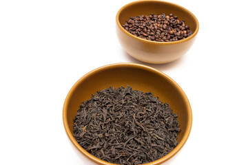 Bowls with coffee and dried tea on a white background