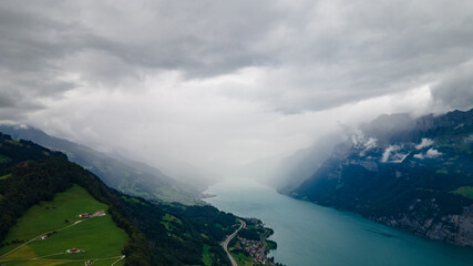 Rain Shower in a valley with the Wallensee and beautiful mountains in Flums Switzerland - Drone Perspective Landscape Photography