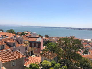 Naklejka premium Aerial view of red roofs of Alfama and the River Tagus in Lisbon Portugal