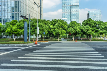 empty road with zebra crossing and skyscrapers in modern city.