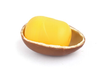 Chocolate egg with toy on white background