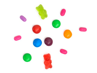 Set of caramel candies and marmalade on white background