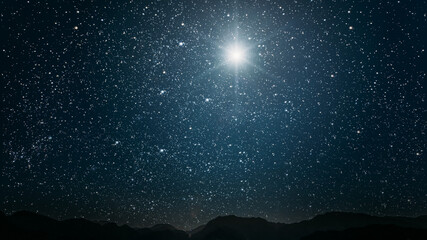 The star shines over the manger of christmas of Jesus Christ.