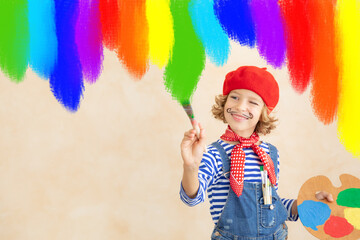 Happy child painting rainbow at home