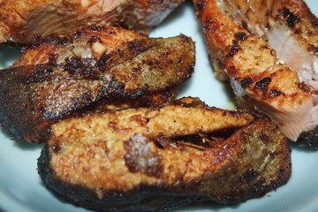 Spicy and crunchy barbecue of fried fish fillet on a white background