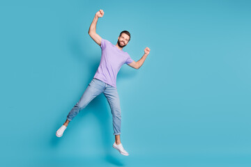Full length body size photo of young student jumping showing muscles biceps triceps smiling...