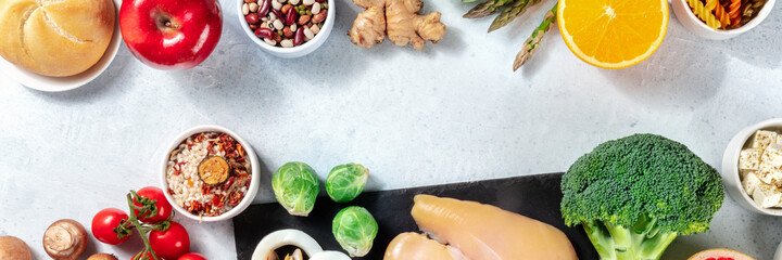 Healthy food panorama with copy space. Top shot of fruits, vegetables, chicken, legumes and rice...