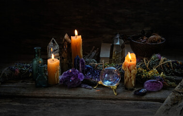 Candles, floral cleansing bundles, magic things, gemstones minerals on dark rustic background....