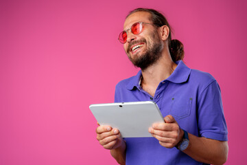 Funny hipster man using his digital tablet