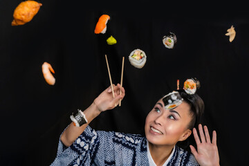 Japaense Kimono model eating sushi with chopstick