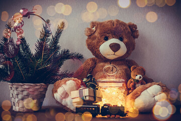 Christmas card with big and small Teddy bear, present gift box on toy locomotive, decorated...