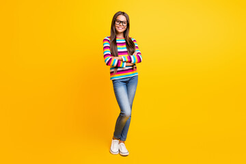 Fototapeta na wymiar Full length body size photo of little girl long hair folded hands smiling wearing jeans jumper isolated on bright yellow color background