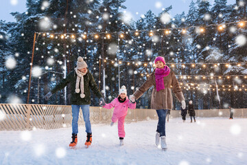 christmas, family and leisure concept - happy mother, father and daughter at outdoor skating rink in winter over snow - obrazy, fototapety, plakaty
