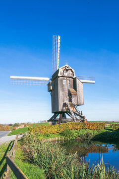 image of beautiful blue sky with old windmill for make flour powder to make bread at a countryside in Belgium.