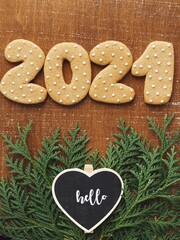 2021 gingerbread date on wooden background with fir 