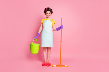 Full size photo of positive girl wife hold mop bucket wear dotted dress slippers isolated on pastel color background