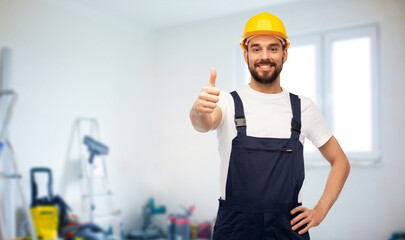 repair, construction and building concept - happy smiling male worker or builder in yellow helmet...