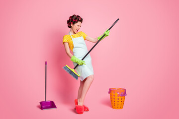 Full length body size view of overjoyed playful maid cleansing floor pretending playing guitar...