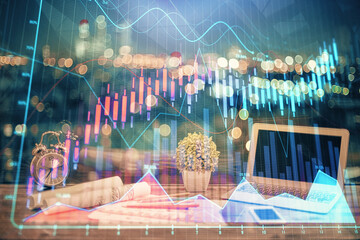 Double exposure of chart and financial info and work space with computer background. Concept of...