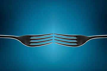 Two forks on a blue background