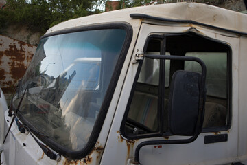 Close up shot to an abandoned half cut van. In a truck graveyard. Awaiting dismantling or recycling.