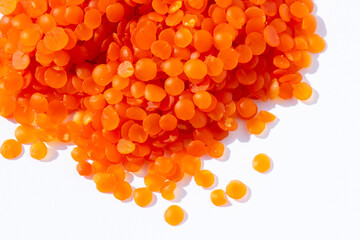 red lentil grains on a white background