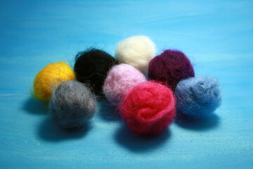 Balls of colored wool for making beads.