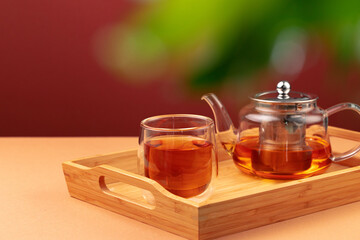 Glass teapot and cup with black tea