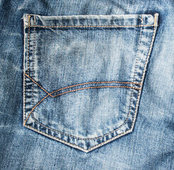 Fragment of back pocket blue jeans. 