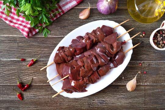 Pieces of raw pork liver on wooden skewers for cooking barbecue. Diet dish. Asian cuisine. The top view