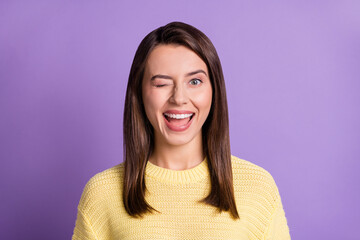 Fototapeta premium Photo portrait of winking young girl with closed eye smiling isolated on bright color purple background