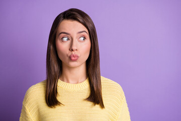 Photo portrait of pretty girl sending air kiss with plump pouted lips looking at blank space isolated on bright color purple background