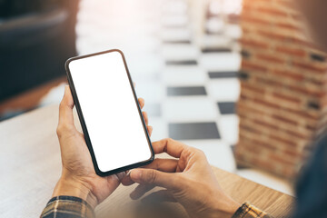 cell phone blank white screen mockup.woman hand holding texting using mobile on desk at office.background empty space for advertise.work people contact marketing business,technology