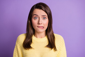 Photo portrait of stressed guilty female student biting lip looking upset wearing yellow sweater...