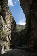 Point of view inside the breathtaking Venetikos river in Portitsa Gorge. Part of the sky appears between the high cliffs of 150-200 meters. Grevena, Greece.