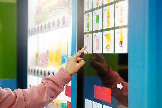sell, technology and consumption concept, Woman buying with a vending machine