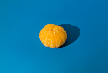 Peeled tangerine on a blue background. isolate
