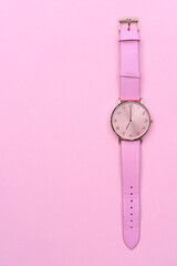 Pink watch isolated on pink background. 7 o'clock. 