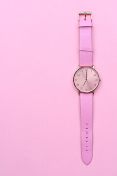 Pink Watch Isolated On Pink Background. 7 O'clock. 