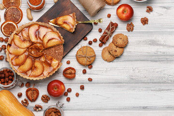 Top view of an apple pie on white wooden surface