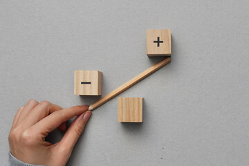 Symbolic scales and cubes with drawings of plus and minus. The preponderance of arguments in the...