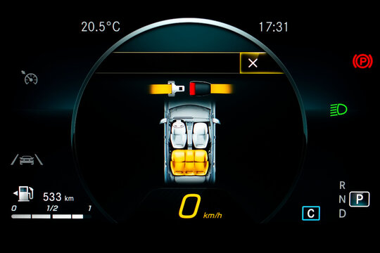 Close up of car dashboard panel showing seat belt reminder. Modern car digital LCD instrument cluster with speedometer, fuel gauge, lane assist icon, gear position indicator. Fastening belt symbol.