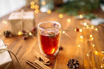 Glass mug of tea with star anise and garland light