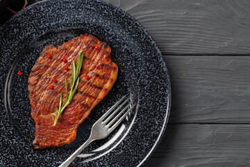 Grilled beef steak served on plate close up